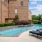 Resort-style swimming pool with ample lounge seating at Alto Highland Park